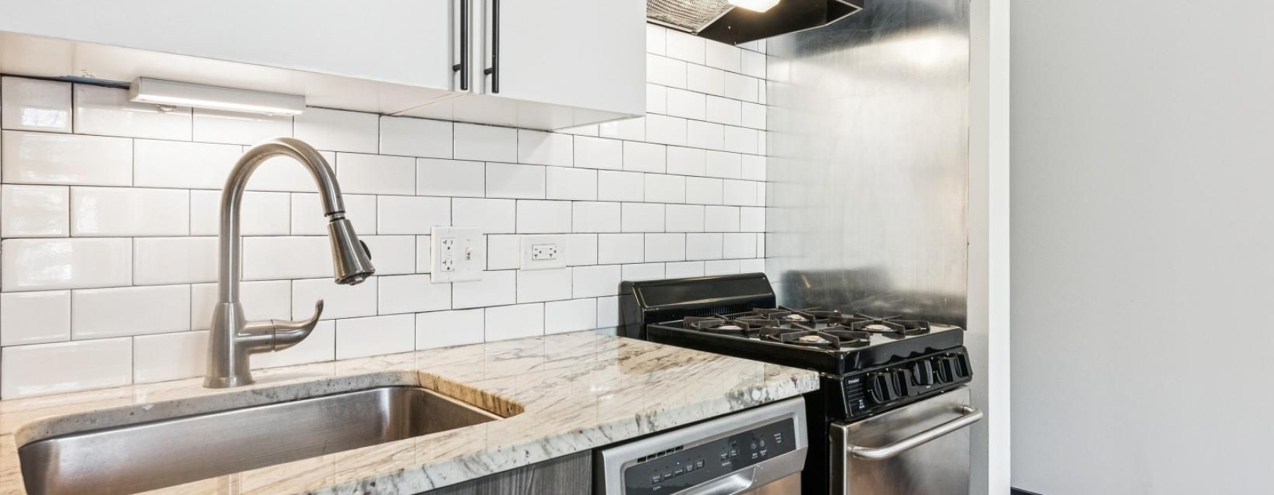 a kitchen with white cabinets