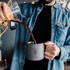 a man holding a coffee cup