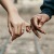 two people linking fingers