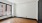 a room with a wood floor and a window